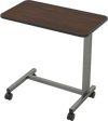 Overbed table with walnut finish, adjustable height, and lockable wheels for home or hospital use.