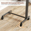 Overbed table features lockable rolling wheels and a sturdy H-shaped base, ideal for home and hospital use.