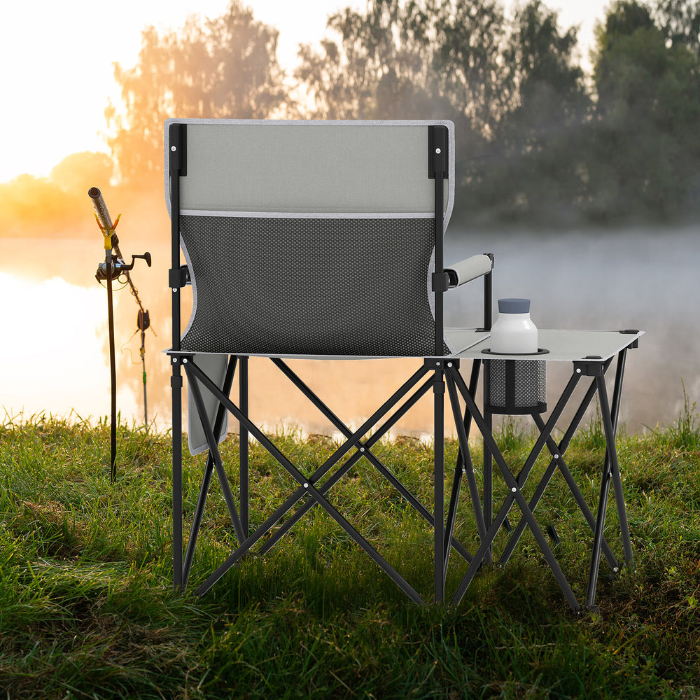 Oversized gray camping chair with side table, cup holder, and storage pockets, ideal for outdoor relaxation by the.