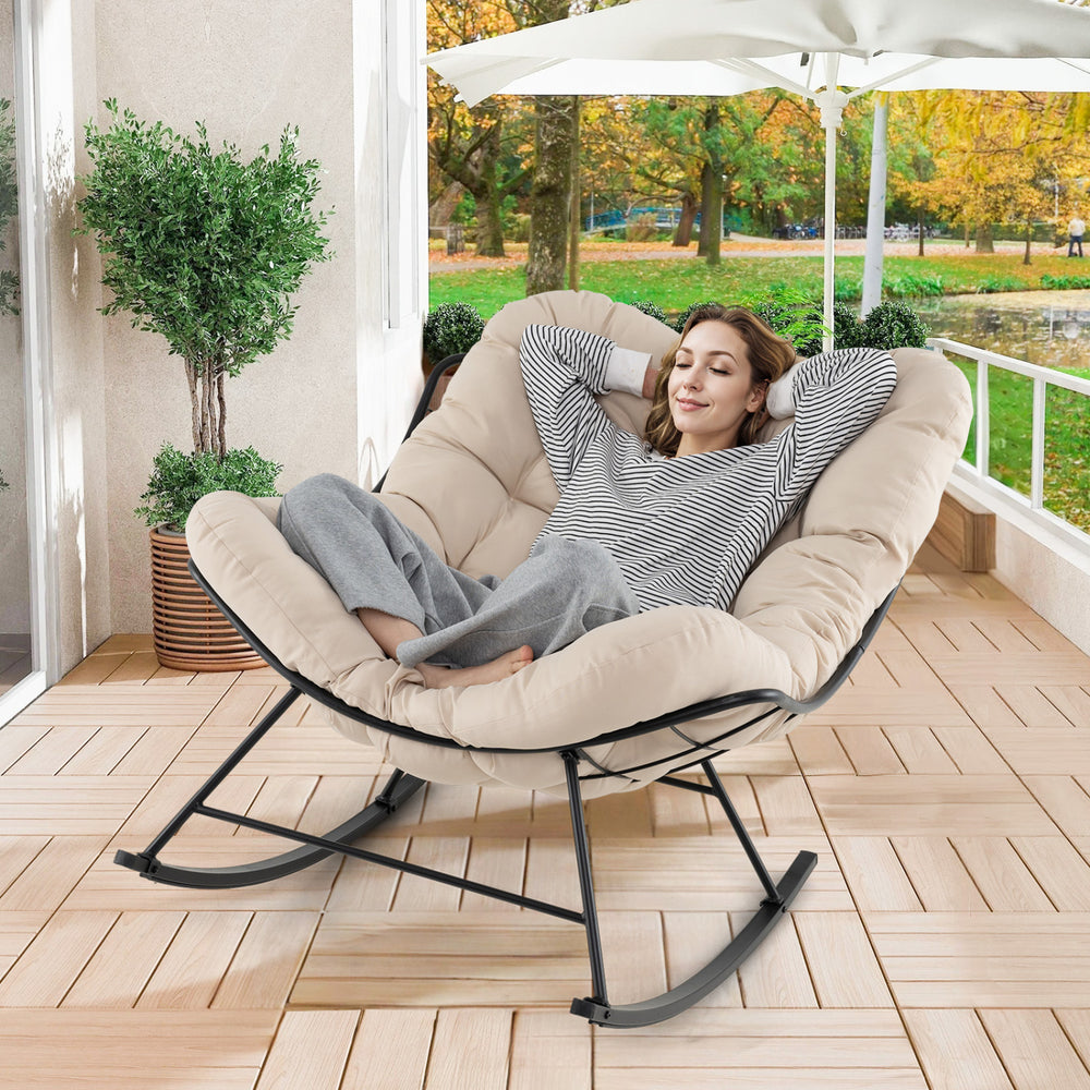 Oversized egg Papasan chair with padded beige cushion, designed for comfort and relaxation on the porch or patio.