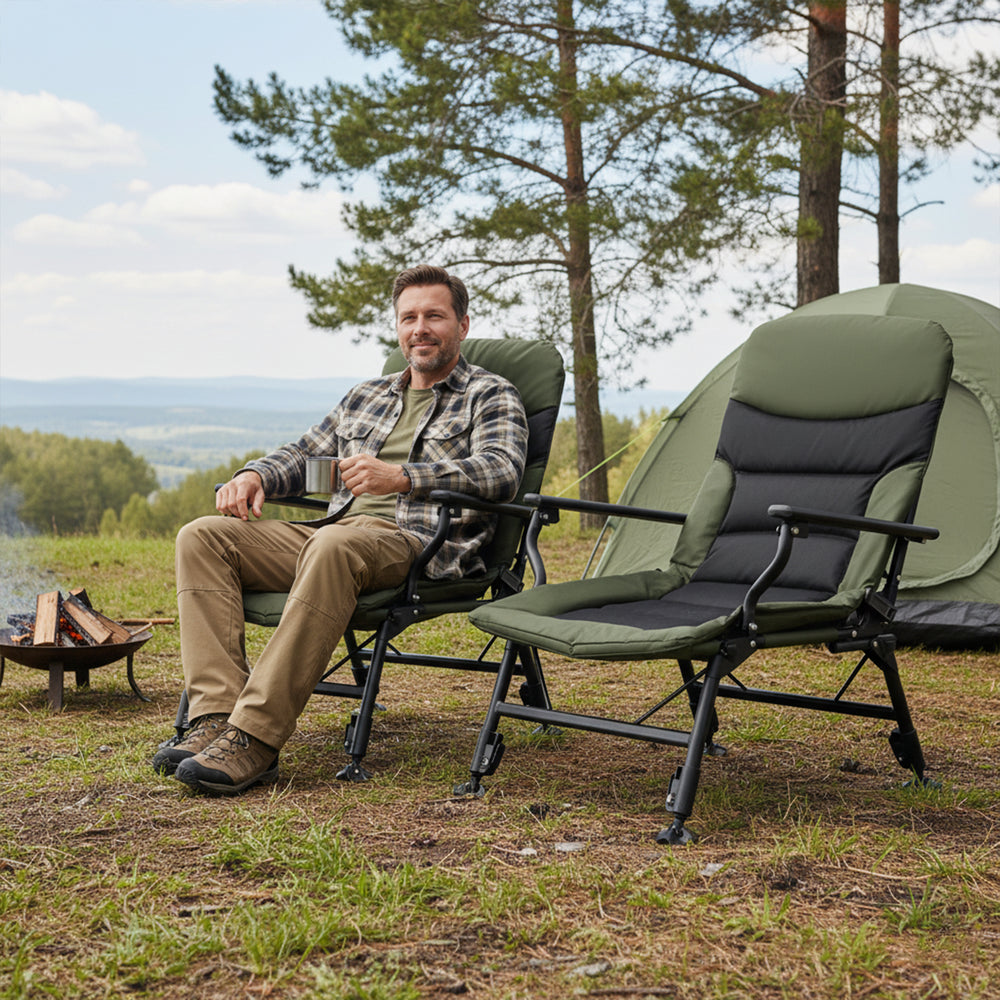 Oversized foldable fishing chair in green with adjustable backrest and armrests, perfect for camping or lounging.