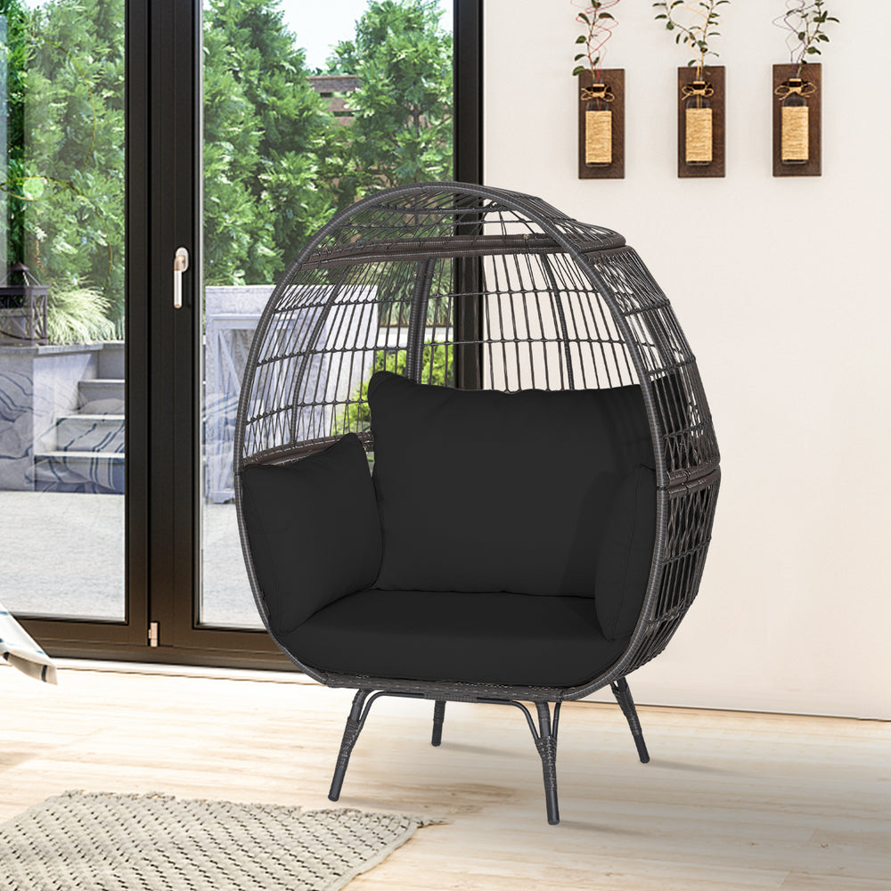 Oversized black wicker egg chair with sturdy metal frame and thick cushions, perfect for cozy indoor or patio.