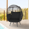 Oversized black wicker egg chair with sturdy metal frame and thick cushions, perfect for cozy patio relaxation.