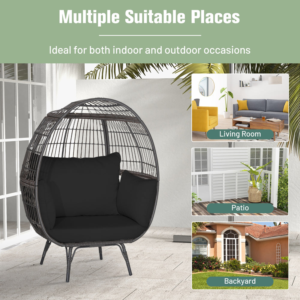 Oversized black wicker egg chair with sturdy metal frame and thick cushions, perfect for indoor or outdoor relaxation.