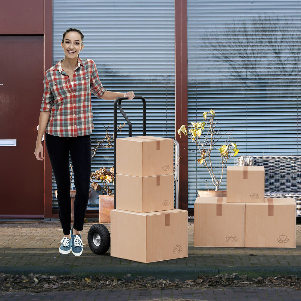 P-handle hand truck with foldable load plate, featuring heavy-duty metal construction and double bearing wheels for.