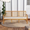 Patio 64-inch acacia wood bench with off-white seat cushion, ideal for backyard or garden seating.