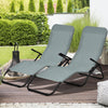 Two light green folding patio chaise loungers with rocking design, perfect for outdoor relaxation in the garden or.