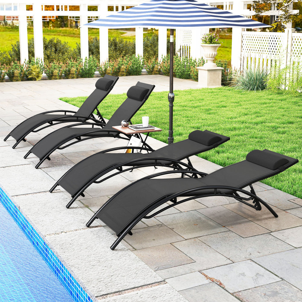 Side view of two black patio chaise lounges with ergonomic design and adjustable headrests, ideal for outdoor comfort.
