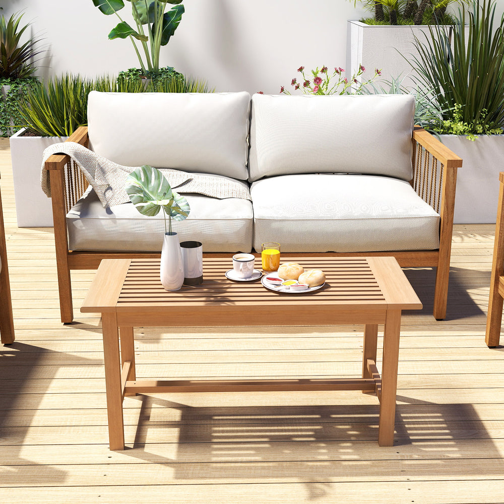 Teak wood patio coffee table with a slatted design, perfect for placing food and drinks in garden or poolside settings.
