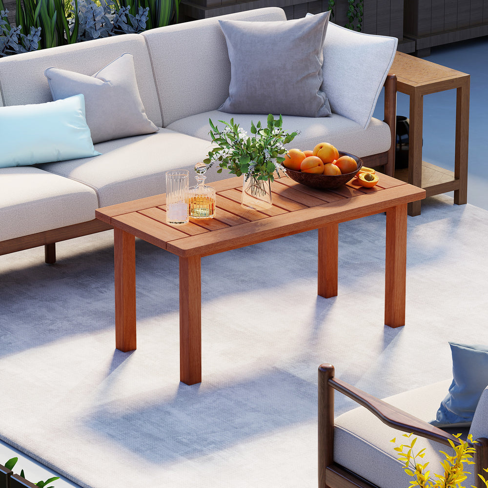 Patio coffee table with a natural wood finish, perfect for holding drinks and snacks during outdoor relaxation.