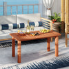 Patio coffee table with slatted wood design, showcasing drinks and fruits, perfect for outdoor gatherings on the deck.