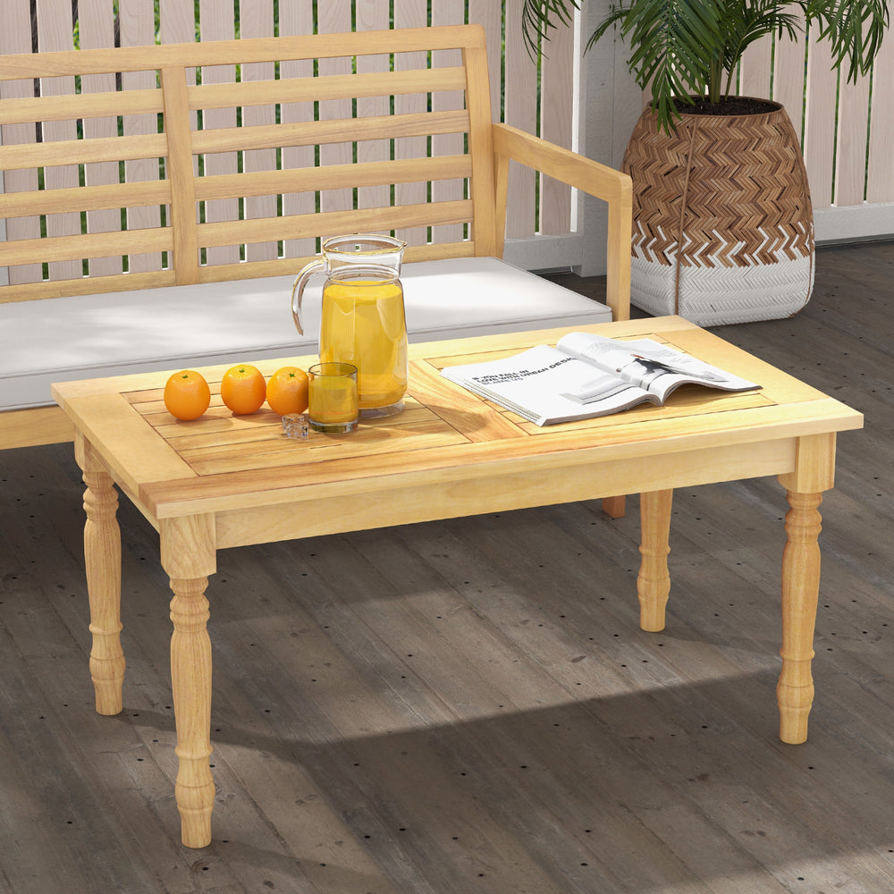 Patio coffee table crafted from solid teak wood with slatted design, ideal for serving drinks and snacks outdoors.
