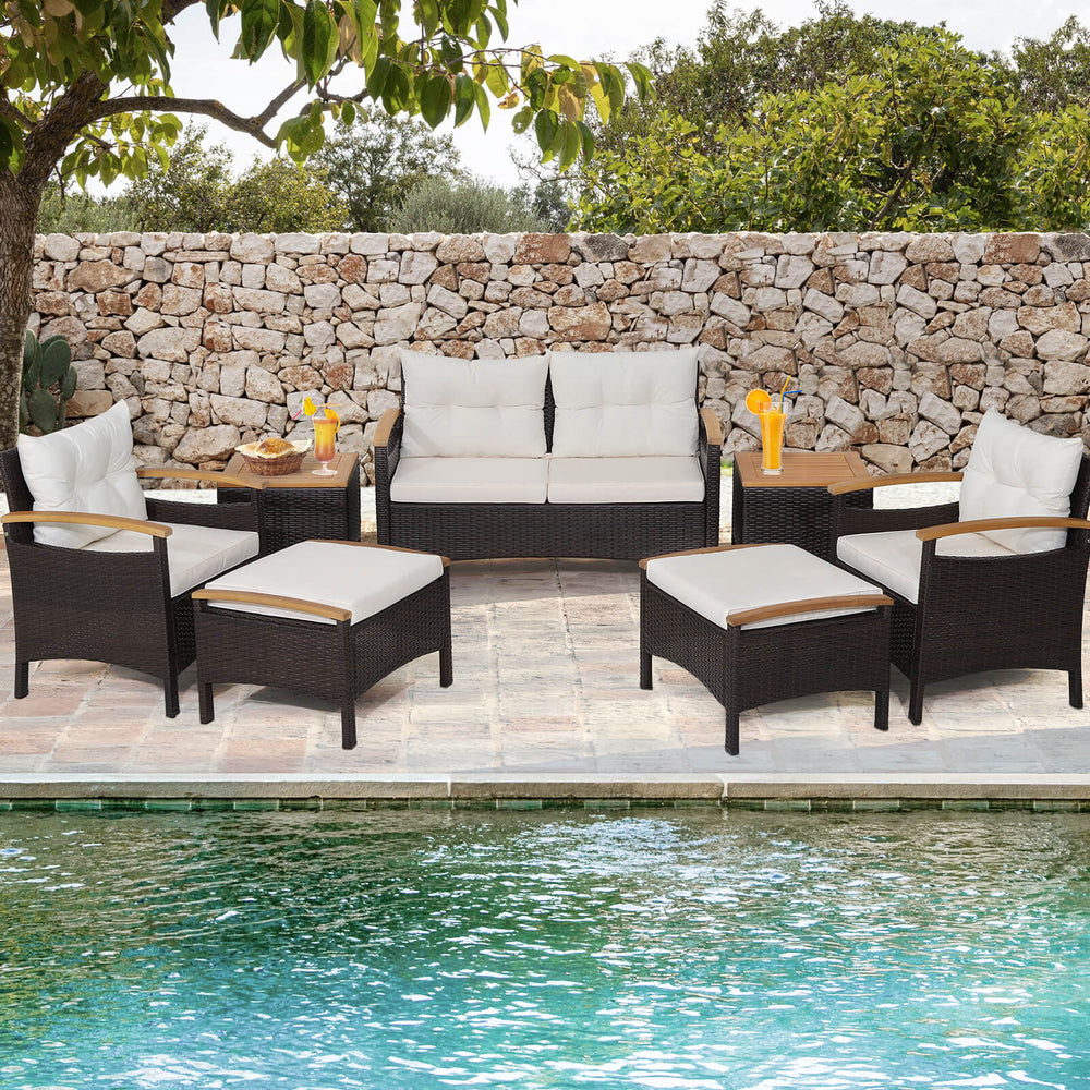 7-piece rattan patio sofa set with acacia wood tabletop, featuring soft cushions, ideal for poolside relaxation.