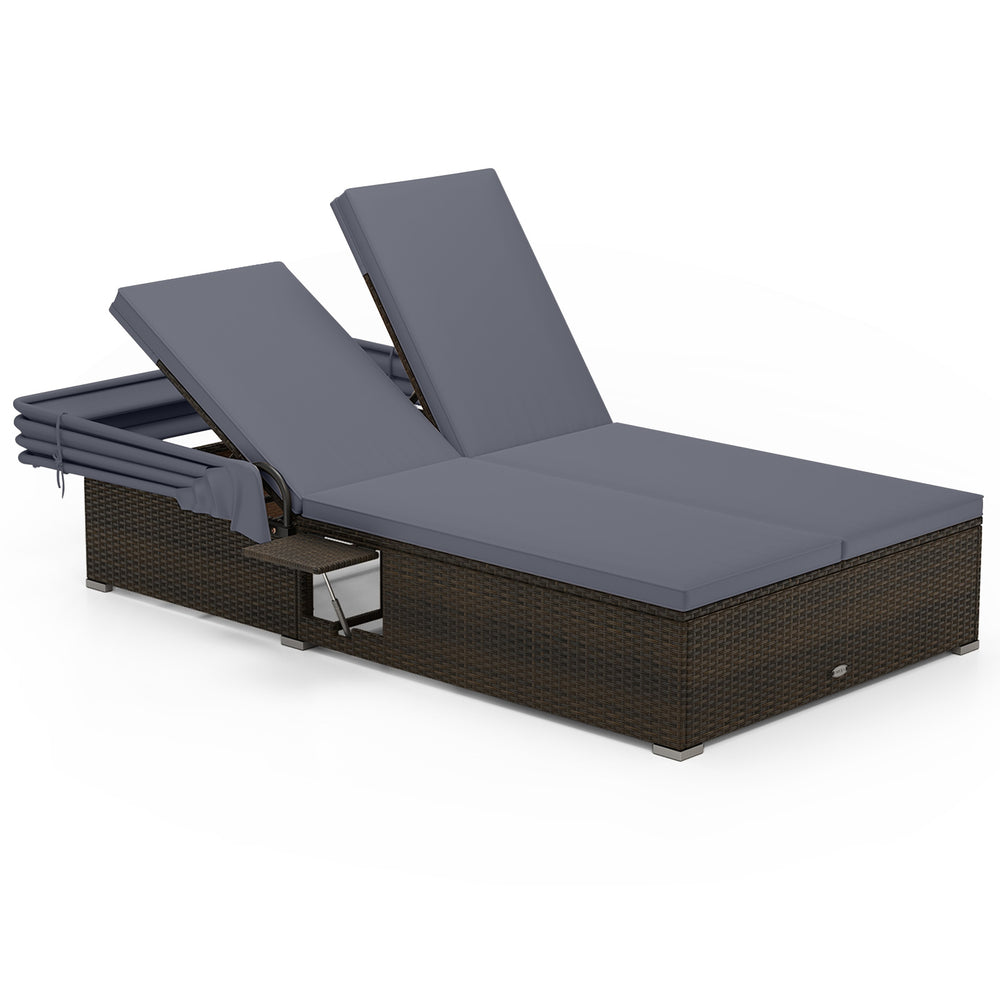 Patio double chaise lounge with gray cushions, adjustable backrests, and folding side trays for backyard relaxation.