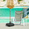 Fillable black patio umbrella base with handle, designed for 1.5-inch poles, placed beside a poolside chair.
