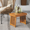 Foldable acacia wood side table with slatted tabletop, ideal for backyard or poolside use, showcasing natural wood.