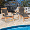 Folding lounge chairs with acacia wood table, featuring brown PE wicker, ideal for poolside relaxation.