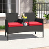Patio loveseat with built-in table, hand-woven PE rattan, red cushions, perfect for backyard or porch relaxation.