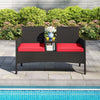 Patio loveseat with built-in table, red cushions, and hand-woven PE rattan, perfect for poolside relaxation.