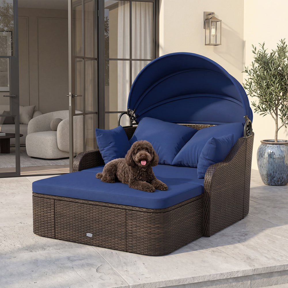 Patio PE rattan daybed with retractable navy canopy and soft cushions, ideal for relaxing in the garden or poolside.