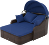Patio PE rattan daybed with retractable canopy and navy cushions, perfect for lounging in the garden or by the poolside.