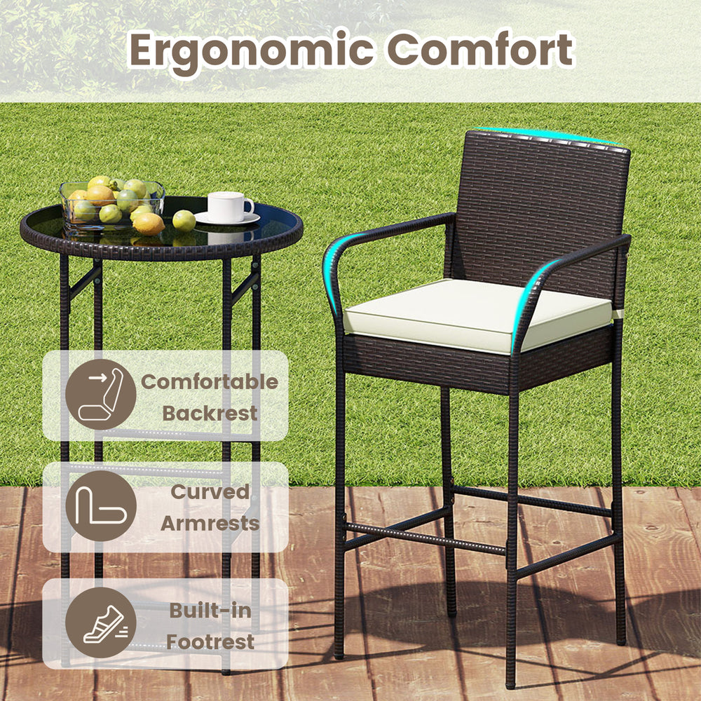 Bar height patio rattan table and chair set with cushions, featuring curved armrests and ergonomic backrest for comfort.