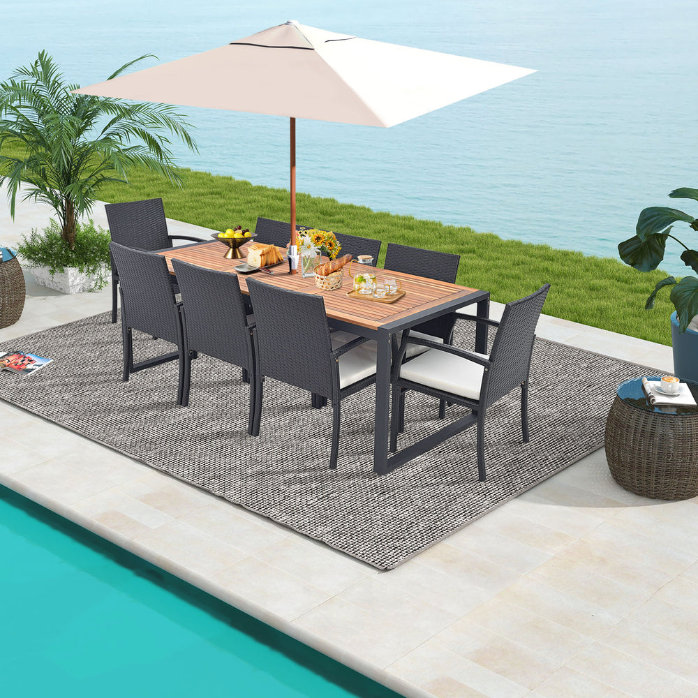 9-piece patio rattan dining set featuring an acacia wood table, perfect for backyard gatherings by the poolside.