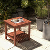 Double-tier acacia wood patio side table with slatted tabletop, perfect for drinks and snacks by the poolside.