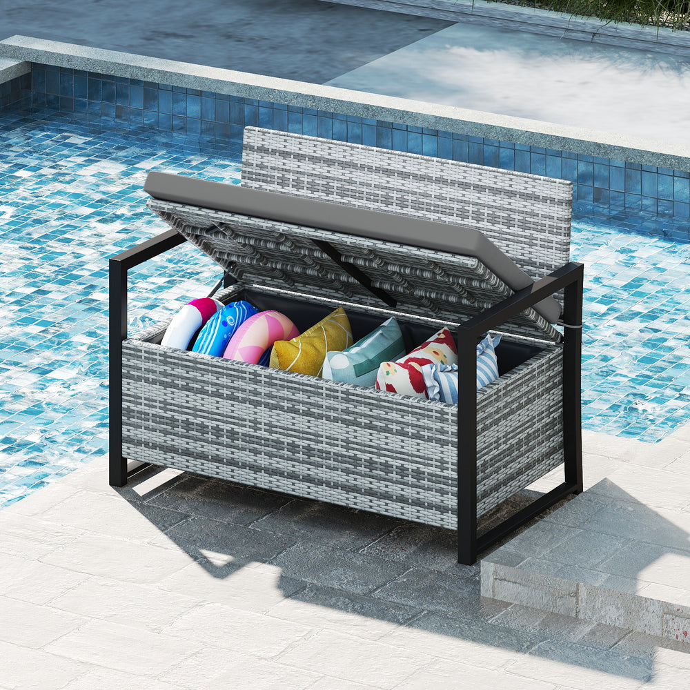 Patio storage bench in gray wicker with built-in storage, ideal for poolside use and accommodating two people.
