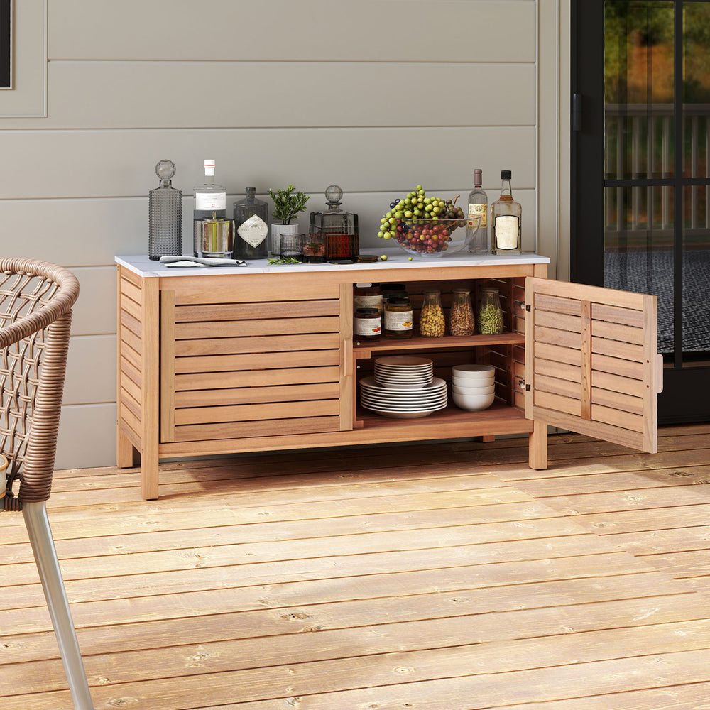 Acacia wood patio storage cabinet with faux marble top, featuring two doors and ample shelving for outdoor essentials.