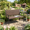 Brown patio loveseat made of sun-proof rattan with soft sponge seat, perfect for garden relaxation.