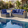 Patio wicker sectional furniture set with navy cushions, featuring an armless sofa and corner sofas by the poolside.