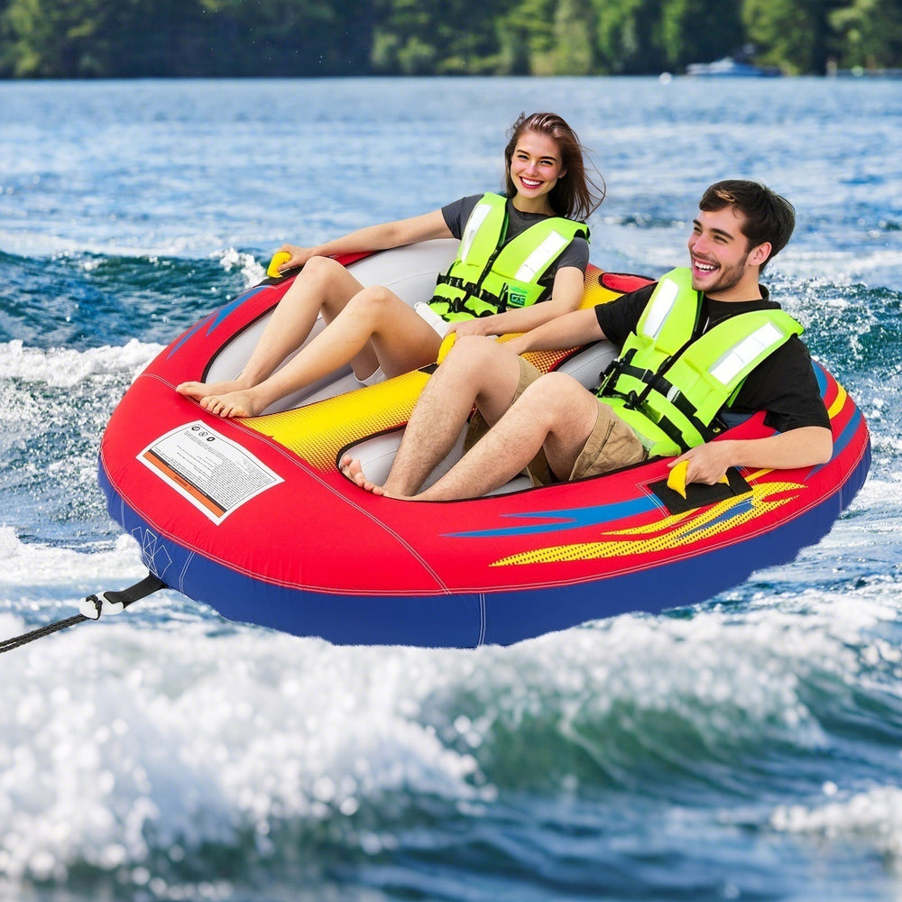 Two people enjoying the 1 or 2 Person Inflatable Towable Tube for Boating on the water, featuring thick padded handles.