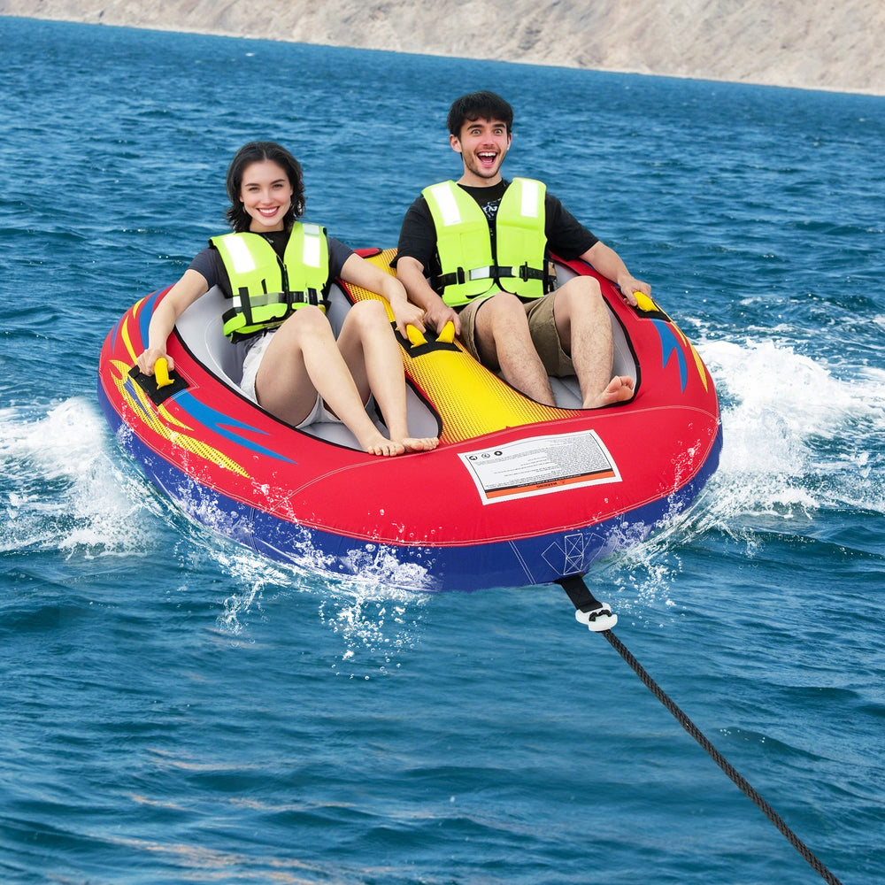 Two people enjoying the 1 or 2 Person Inflatable Towable Tube on water, featuring heavy-duty PVC and padded handles.
