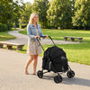 Pet stroller for small to medium dogs in black, featuring a foldable design and breathable mesh windows for comfort.