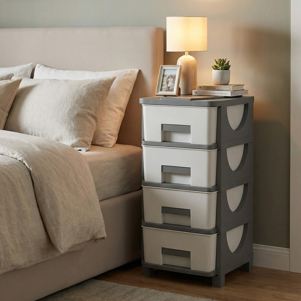 Compact gray plastic storage organizer with four drawers and spacious tabletop, ideal for bedroom use and easy access.