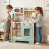 Wooden play kitchen set in green with accessories, chalkboard, and ample storage for kids aged 3+, perfect for.