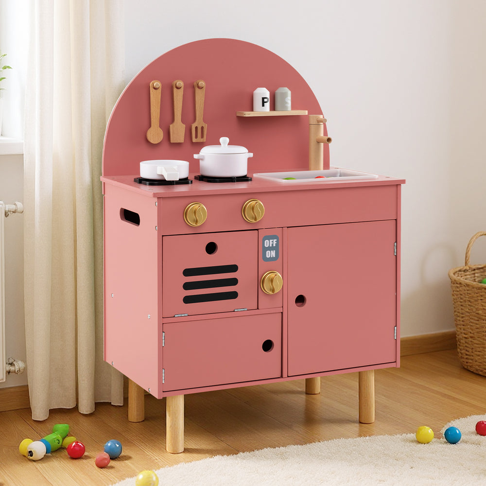 Wooden play kitchen set in pink with stove, sink, and microwave, designed for kids aged 3+, promoting creativity and.