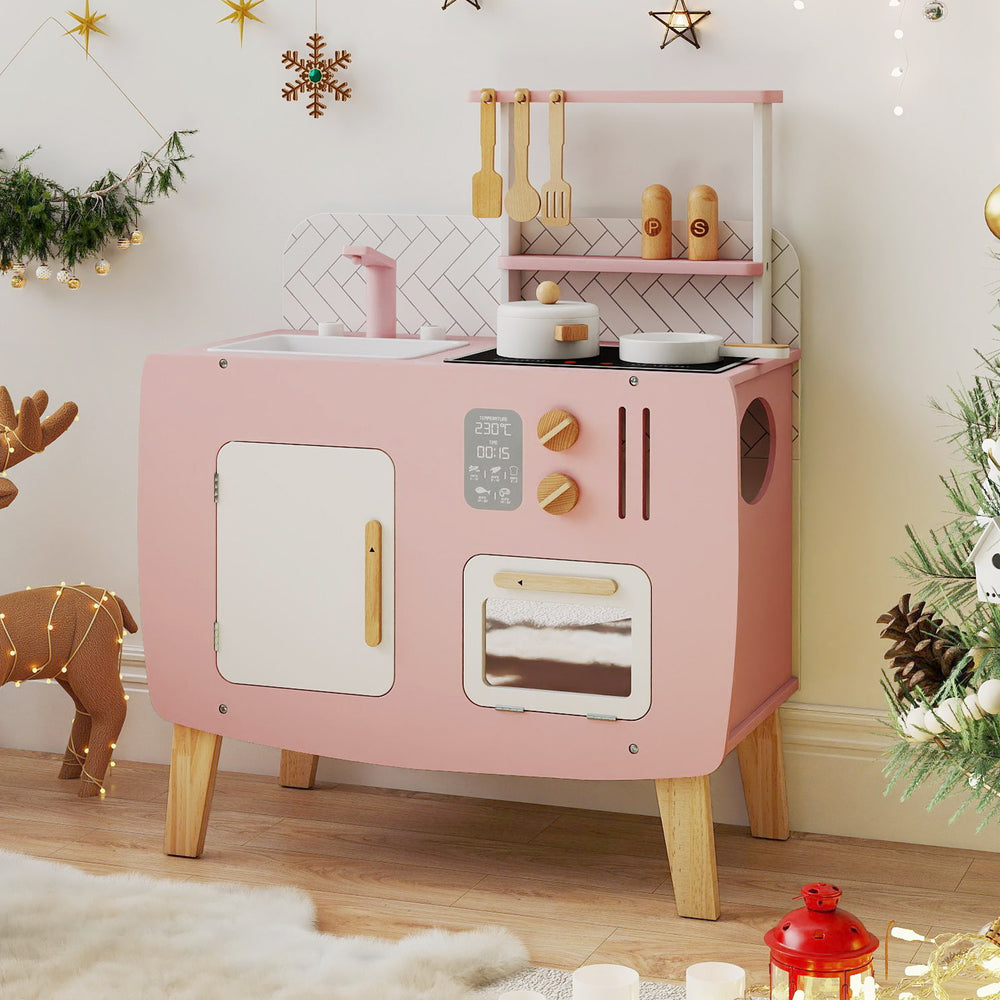 Wooden play kitchen set in pink with stoves, sink, and oven, perfect for imaginative play and small spaces.