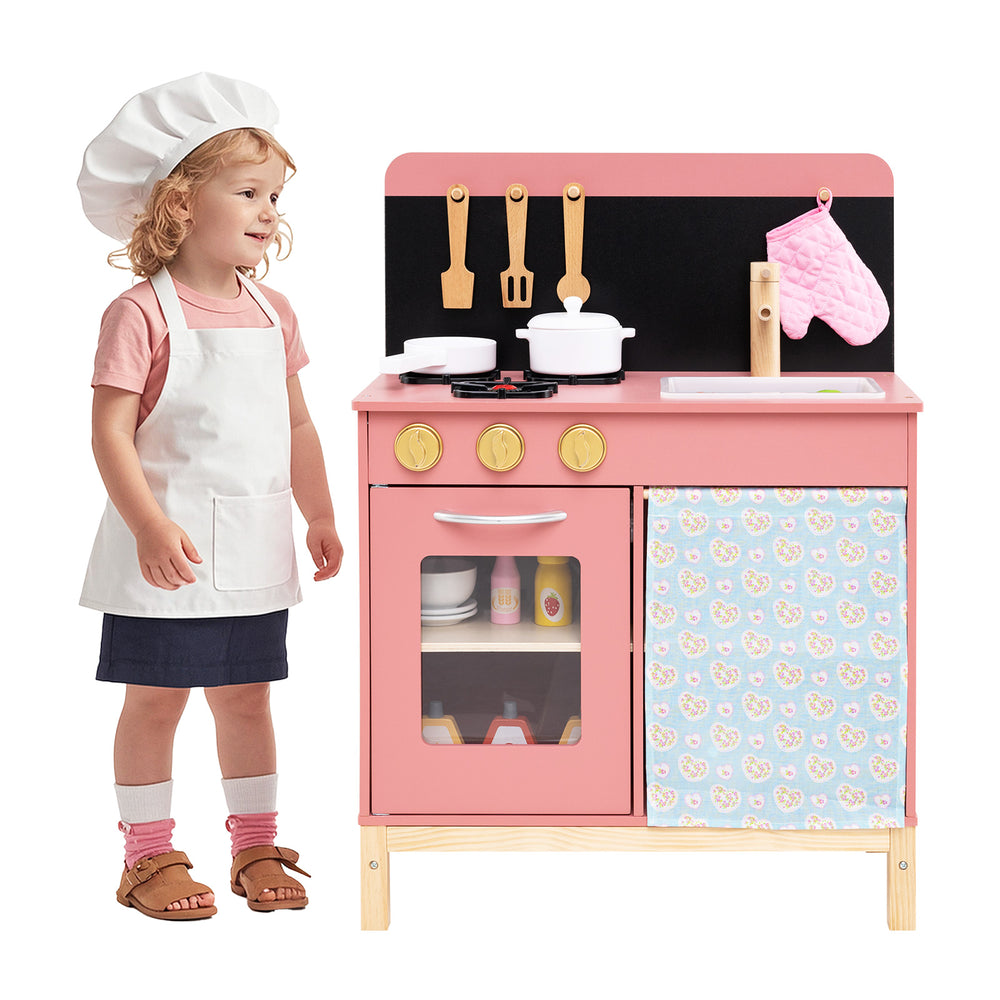 Wooden play kitchen set in pink with stove, sink, and oven, designed for imaginative play for kids aged 3+.