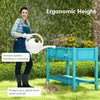 Elevated blue planter box with legs, ergonomic height for easy gardening, featuring drainage holes and storage shelf.