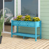 Elevated blue planter box with legs and storage shelf, featuring drainage holes for flowers and herbs on a patio.