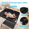 Portable baby changing table in black with adjustable height, raised sides, and storage basket for convenient diaper.