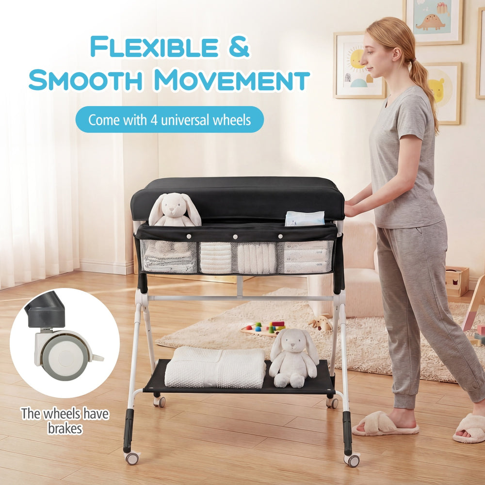 Portable baby changing table in black with adjustable height, spacious storage, and 4 lockable wheels for easy mobility.