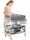 Gray portable baby changing table with a spacious tabletop and two-tier shelf, designed for easy mobility and.