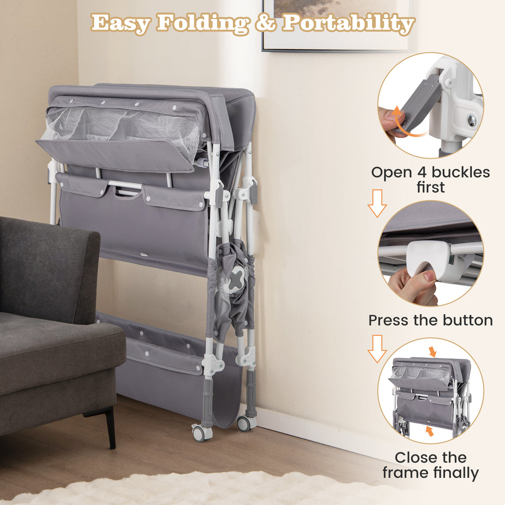 Portable baby changing table in gray with wheels, large storage rack, and easy folding for travel convenience.
