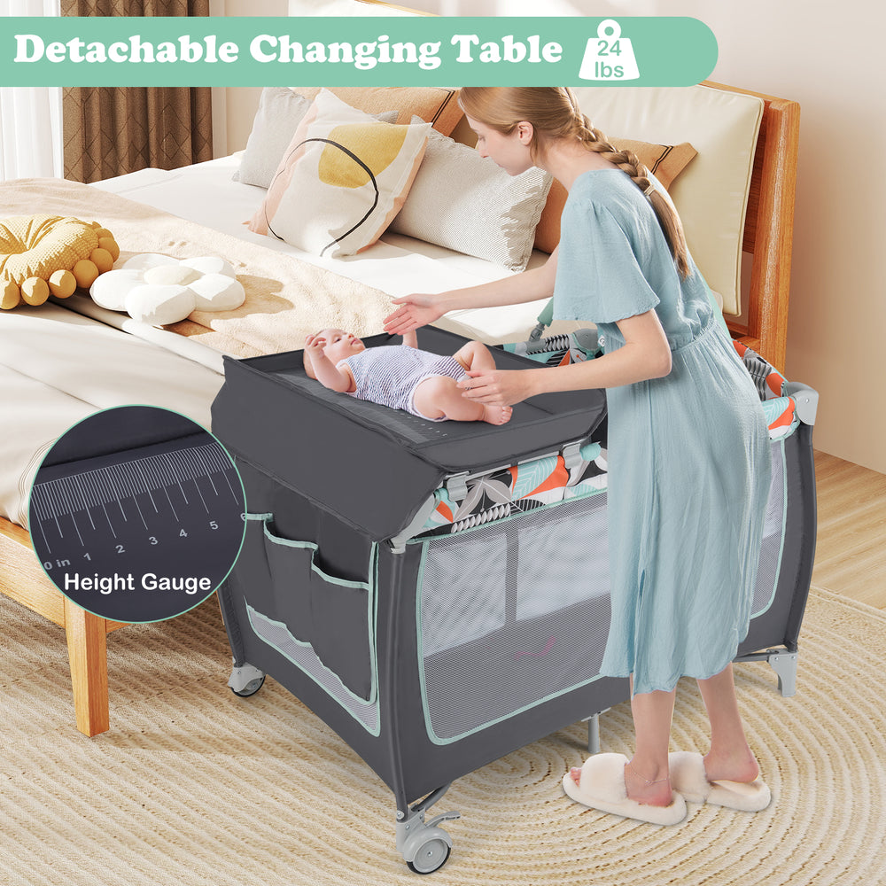 Detachable changing table on the 3-in-1 portable baby playard, featuring breathable mesh and a zippered side door for.