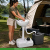 Portable foot pump camping sink with large basin, soap dispenser, and wheels for easy movement at outdoor events.