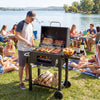 Portable outdoor barbecue grill in black with adjustable charcoal tray, wheels, and large cooking area for outdoor.