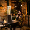 Portable steel tabletop patio heater with glass tube, 10000 BTU, providing 360° heat for outdoor gatherings.